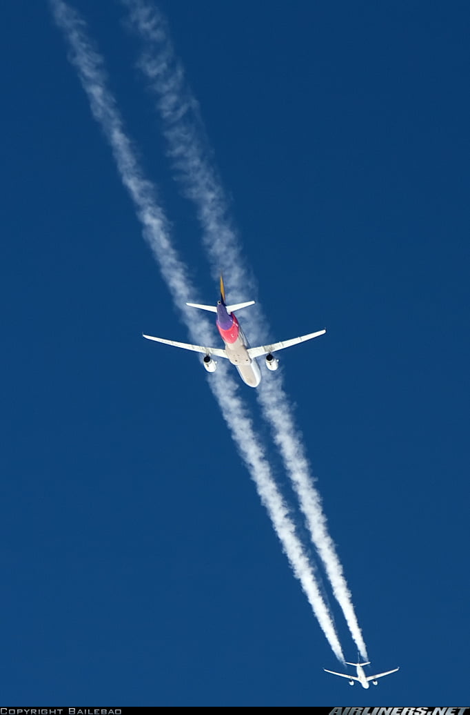 Two planes bound for Hong Kong in the same frame for a split second.